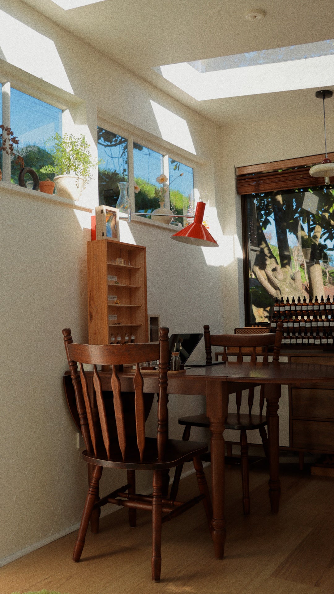 Sunlit perfume workshop room with wooden furniture and scent blending station at SOK Studios in Auckland.