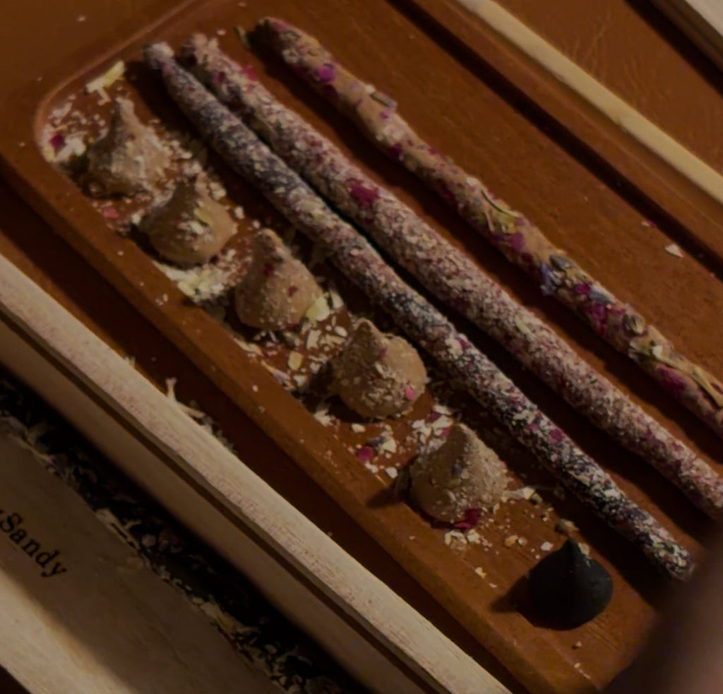 Incense sticks in a holder with text overlay on a dark background