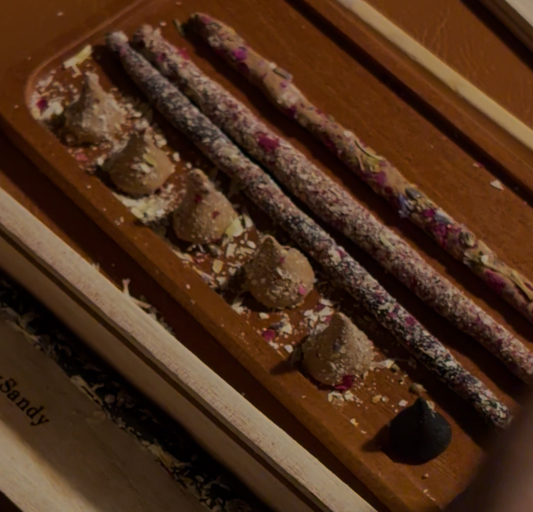 Incense sticks in a holder with text overlay on a dark background